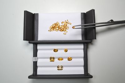 une boîte contenant un tas de pièces d'or et des baguettes