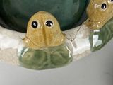 a picture of a ceramic turtle bowl with two little turtles in it