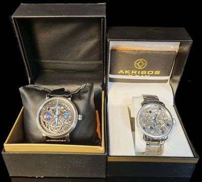 two watches that are in a box on the table
