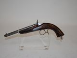 an old gun on display on a clear acrylic stand