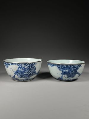 pair of blue and white bowls with dragon design
