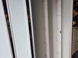 a man that is standing in a room with a bunch of doors