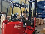 a red forklift in a warehouse with boxes on the floor