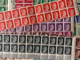 several stamps of different colors and sizes are on a sheet of paper