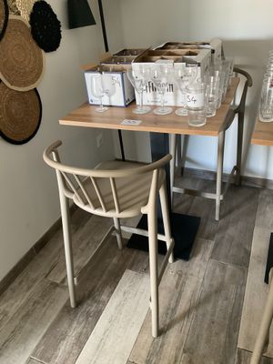 a small table with glasses on it in the corner of a room