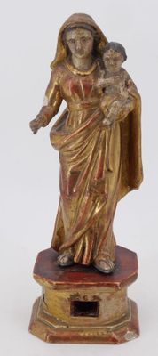 an image of a statue of a woman holding a child on a pedestal