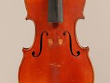 an old violin with a bow hanging from the back
