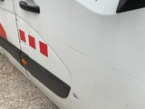 a white van with a red and black stripe on the side of it