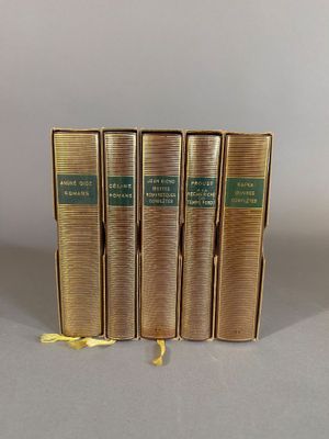 four books are stacked on top of each other on a table