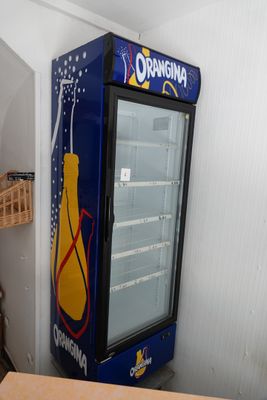 a blue and yellow vending machine in the corner of a room