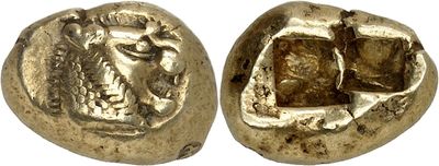 a close up of two gold coins on a white surface