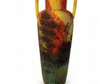 a vase with a painting on it on a white surface