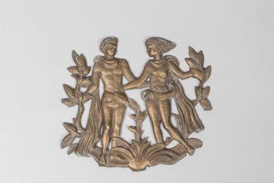 a metal plaque with a man and a woman on it