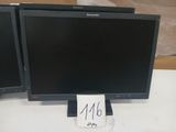 two monitors sitting on a table with a price tag on it