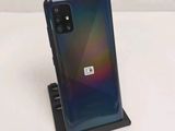 a close up of a phone on a stand on a white surface