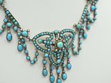 a close up of a necklace on a mannequin mannequin