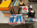 a table with a lot of office supplies on it