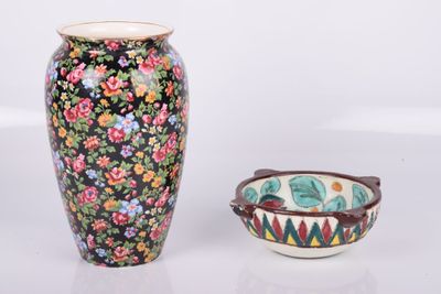 a vase and bowl sitting next to each other on a table