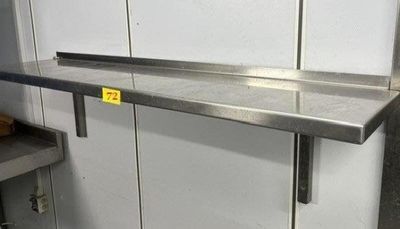 a stainless steel shelf with a yellow tag on it