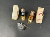 three miniature shoes and a bottle of perfume on a table