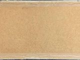 an image of a piece of cardboard on a black surface