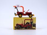 a red toy truck sitting on top of a yellow box