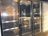 an image of a store with glass doors and a brick wall