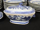 several blue and white plates and bowls are stacked on a black table