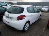 a white car parked in a parking lot with other cars