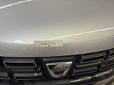 a close up of the front of a car with a sticker on it
