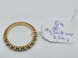 a close up of a gold ring with a tag on it