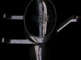 a silver spoon with a black handle on a black background