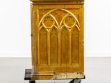 an old wooden cabinet on a dolly in a room
