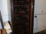 a wine cooler that has a bunch of bottles in it