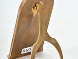 a small brass sculpture of a bird on a stand