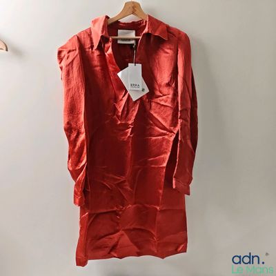 an image of a red shirt hanging on a hanger on a wall