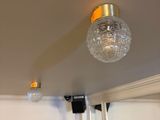 a light that is on above a mirror in a room