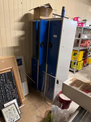 a refrigerator in the middle of a room with a chalk board on the floor