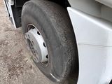 a white truck that has a flat tire on it