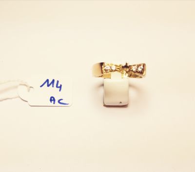 a ring with a diamond on it and a tag with a name on it
