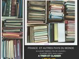 many books stacked on top of each other on a shelf