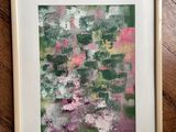 a painting of a green and pink abstract painting on a wooden floor