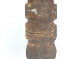 a wooden statue that is sitting on a white surface