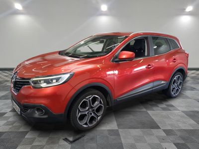 a red car is parked in a room with a checkered floor
