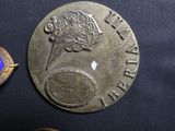 a silver coin with a picture of a flower on it