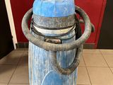 a blue vacuum sitting on top of a tiled floor