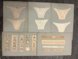 several pieces of paper with various designs on them sitting on a table