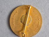 a gold coin with a bar on top of it