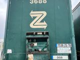 a green truck that is parked in a parking lot