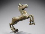 a bronze statue of a horse standing on its hind legs